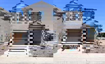 A house with a garage with John Mark Verdier House in the background.