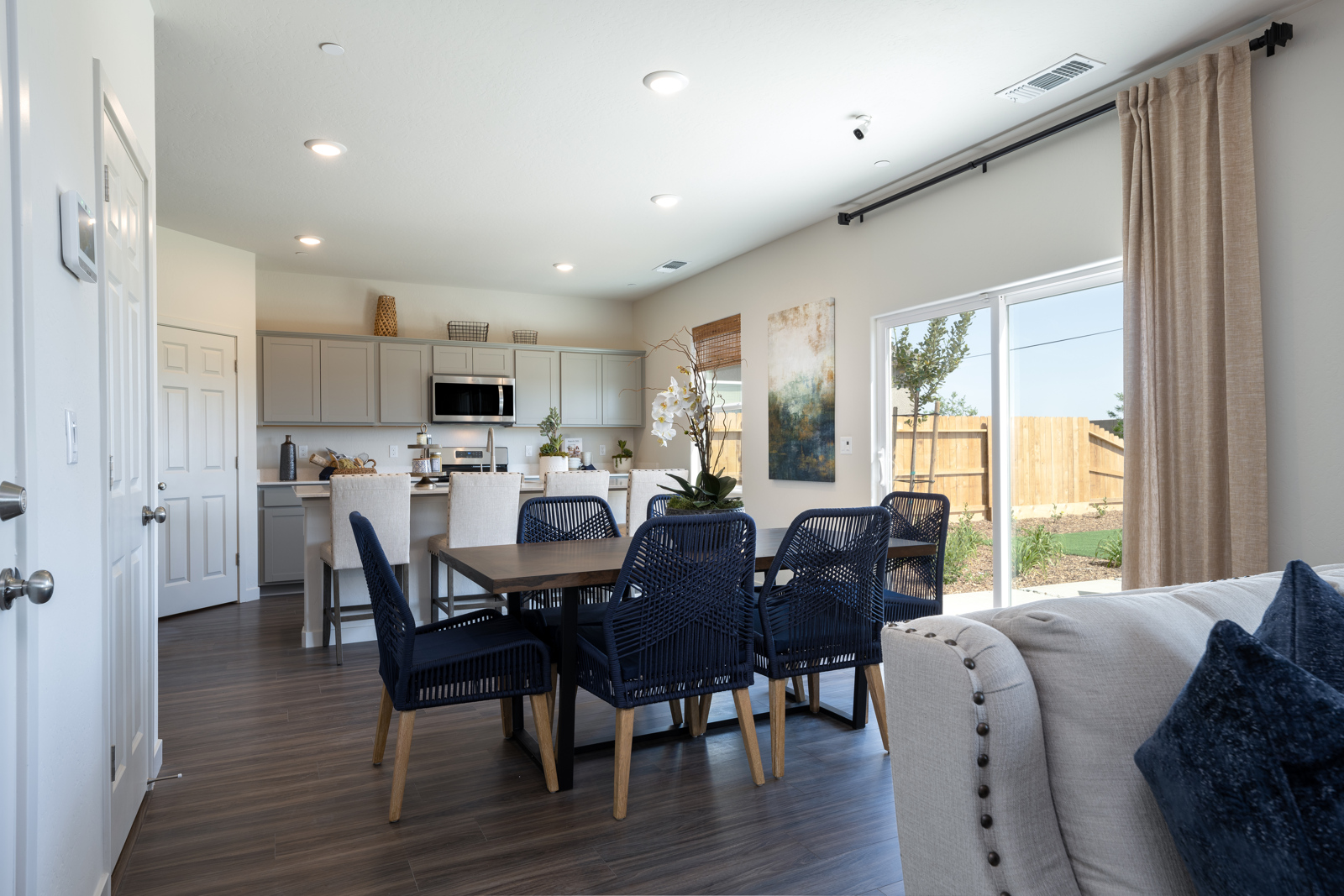 A dining room with a large table and chairs.