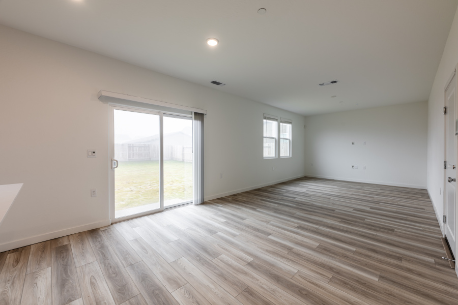 A room with a wood floor and a glass door.
