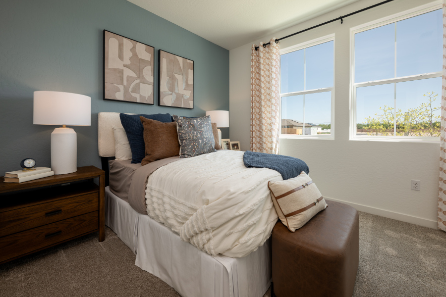 A bedroom with a bed and a lamp.