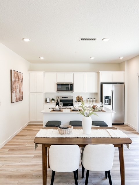 A kitchen with white cabinets.