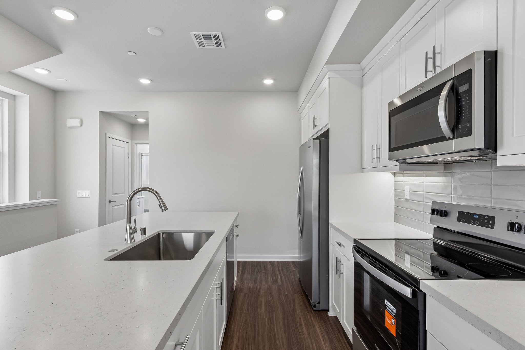 A kitchen with white cabinets.