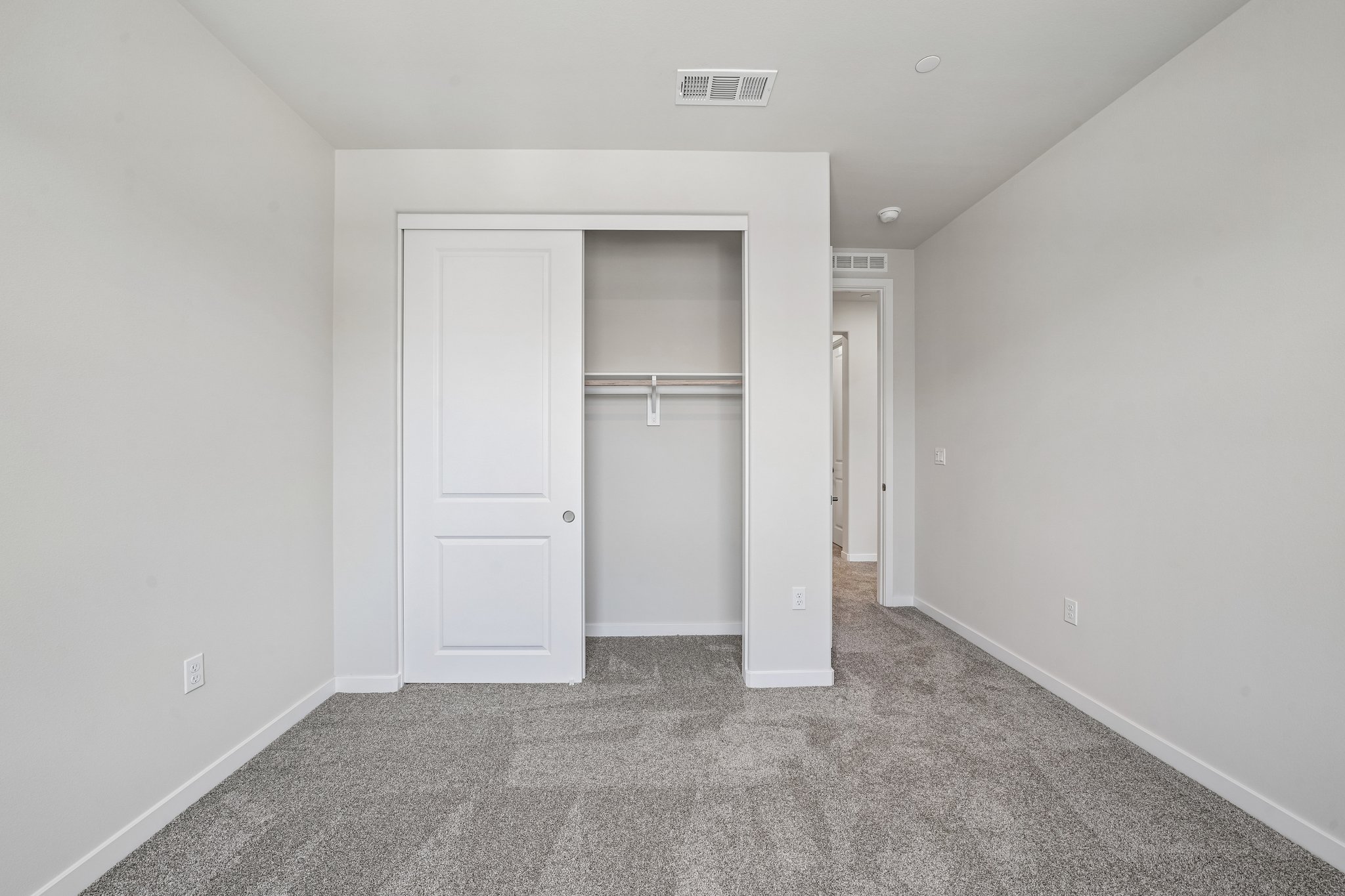 A hallway with white doors.