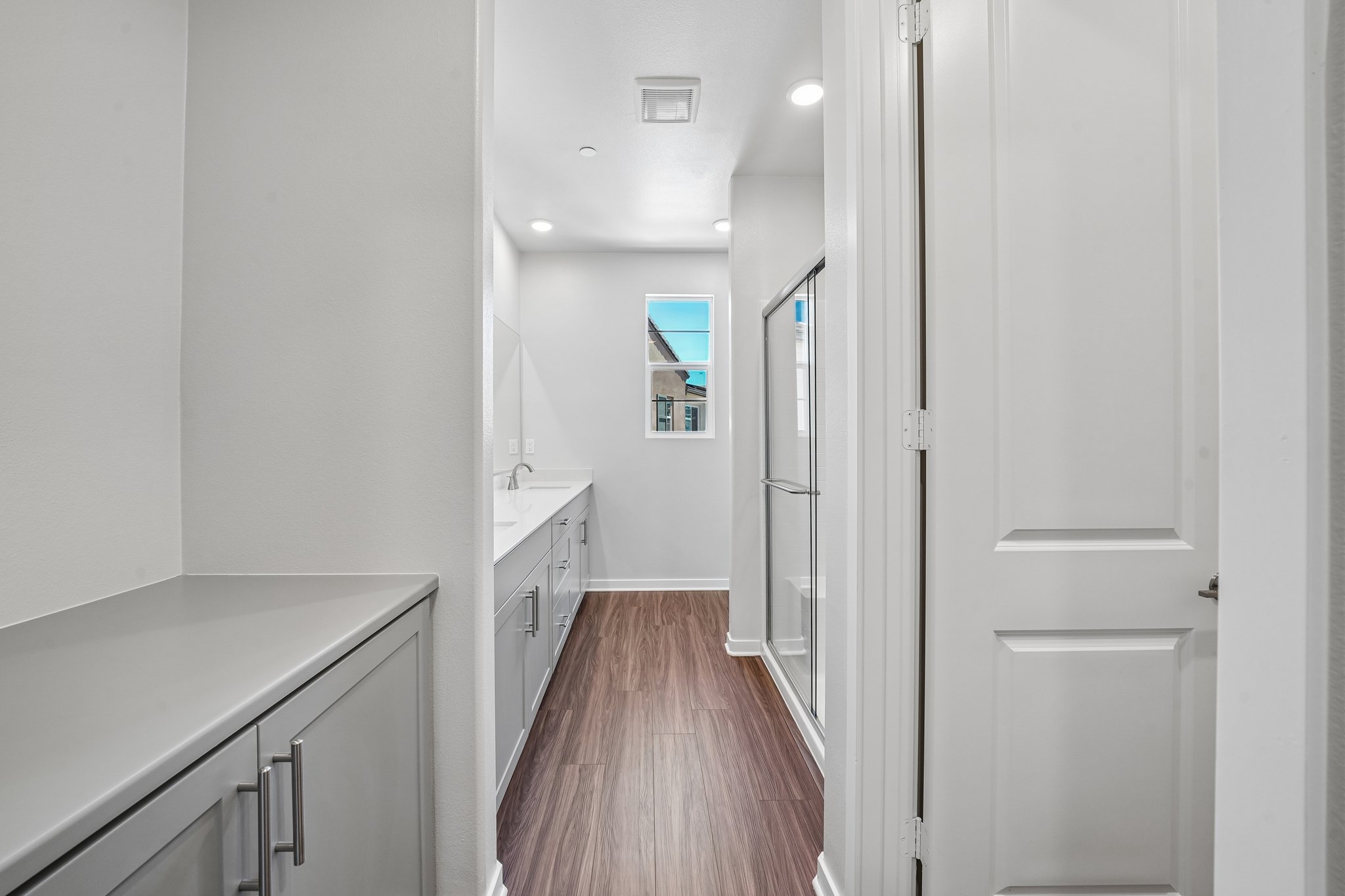 A room with white walls and a wood floor.
