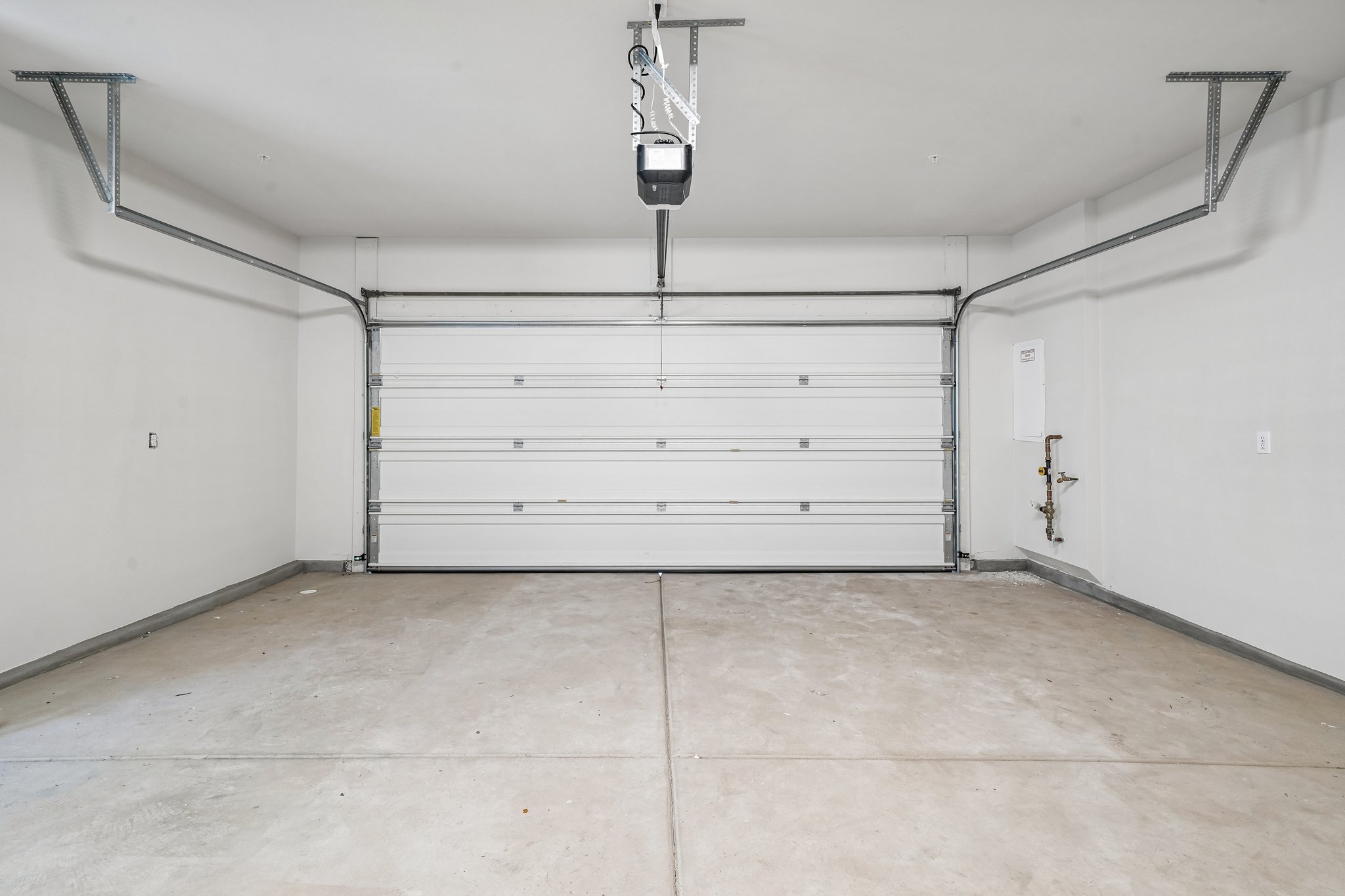 A white garage with a metal door.