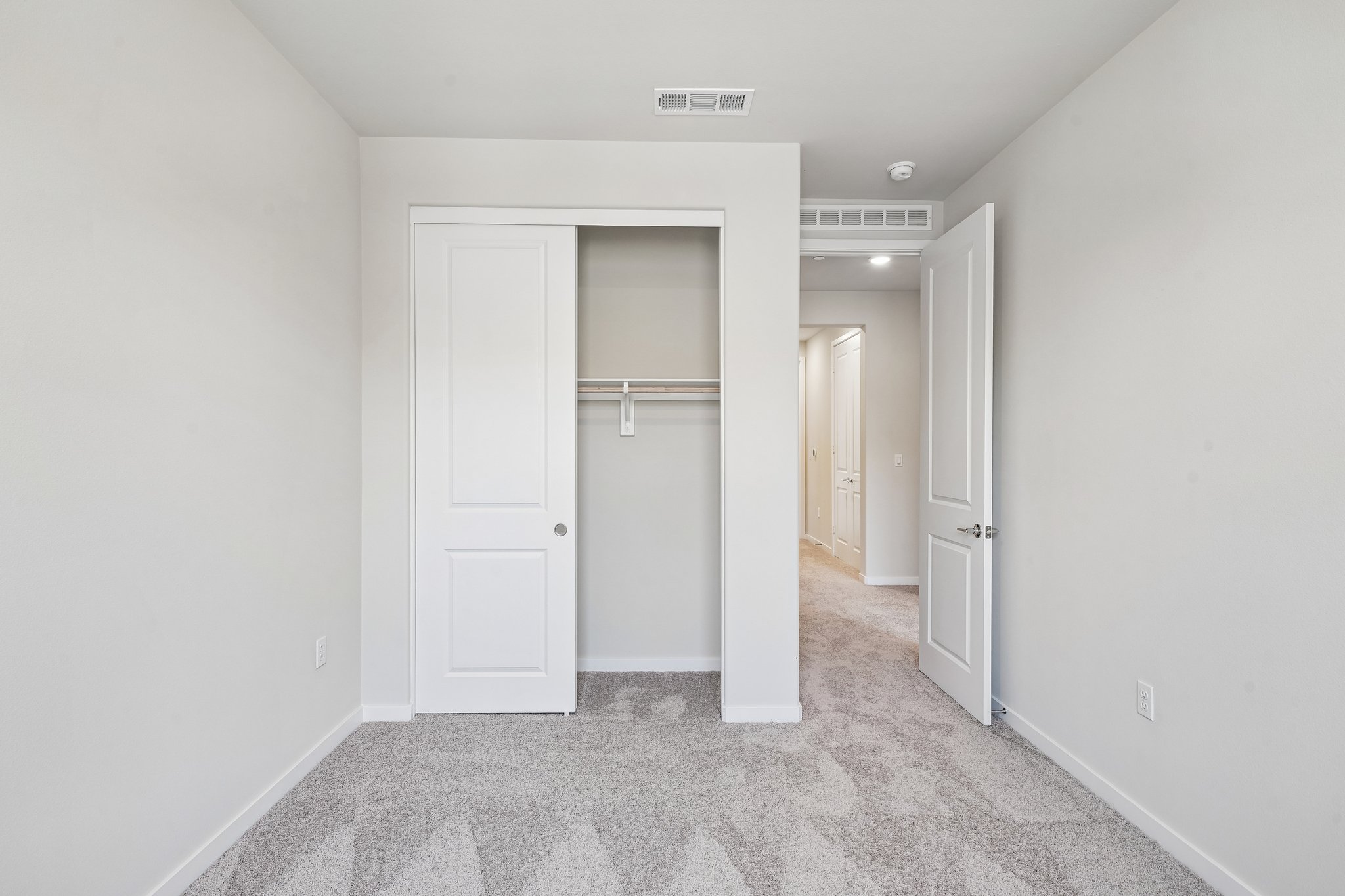 A hallway with white doors.