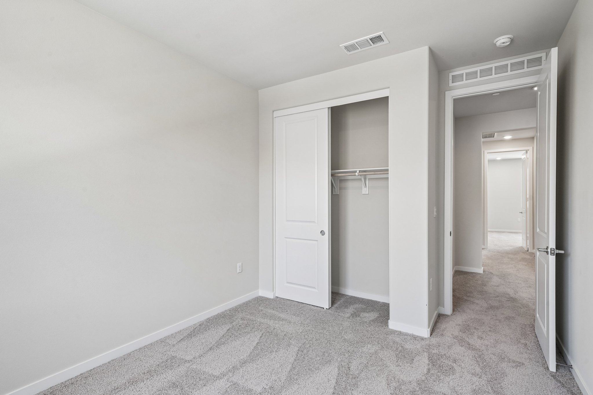 A hallway with white doors.