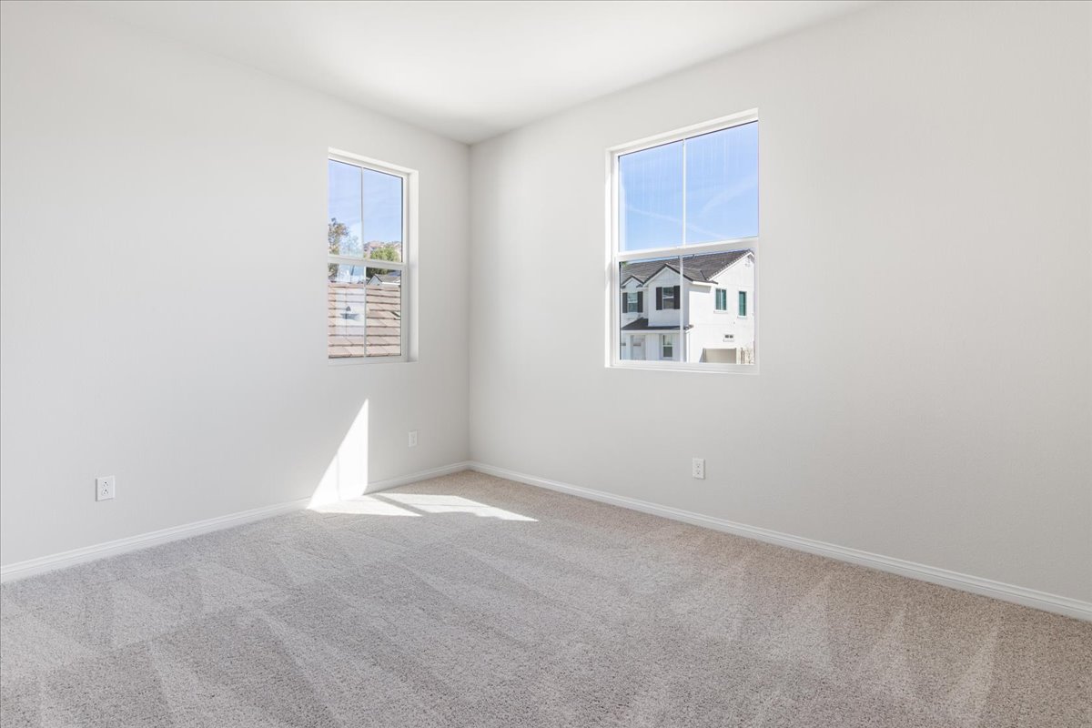 A room with a window and a carpet.
