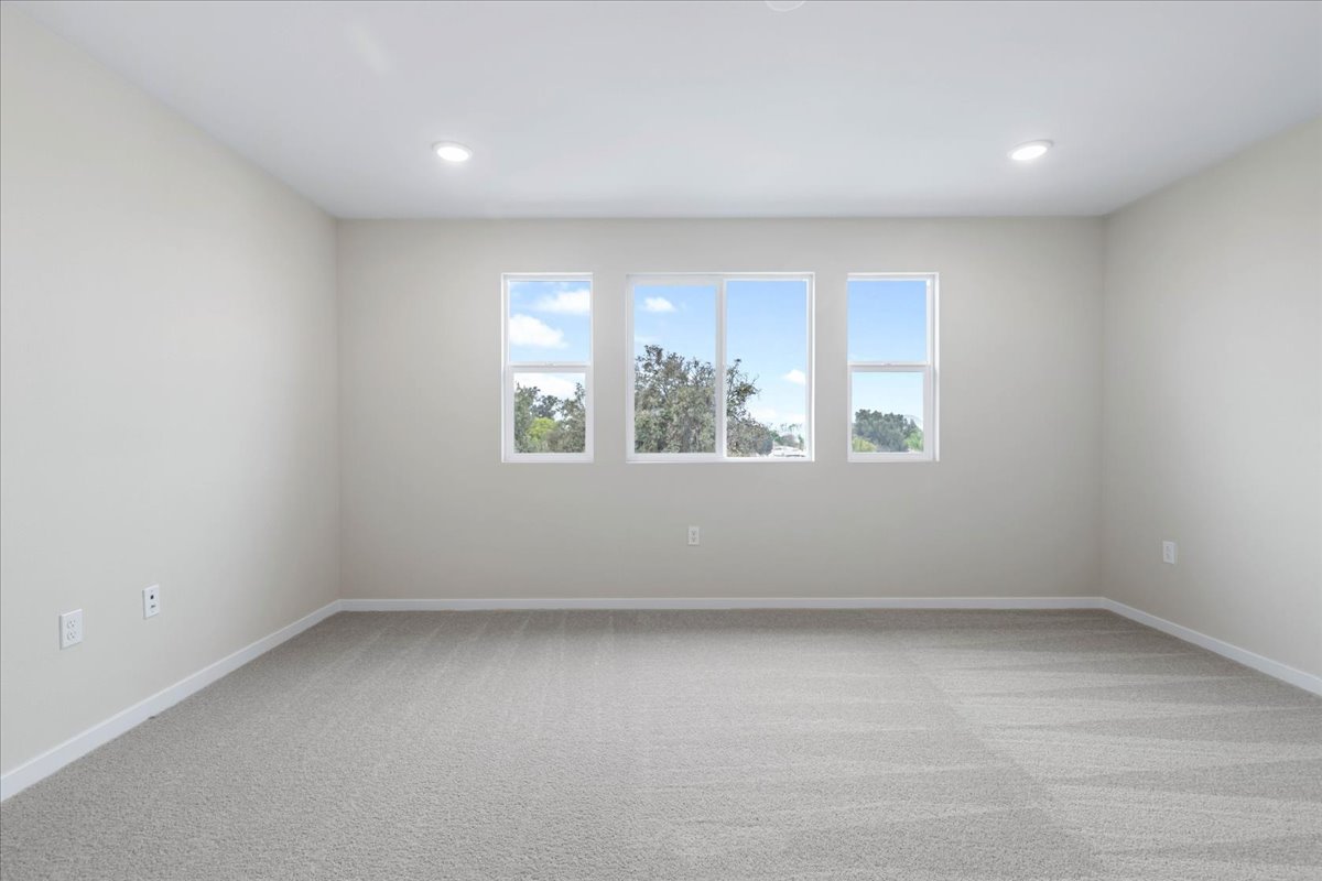 A room with a window and a white wall.