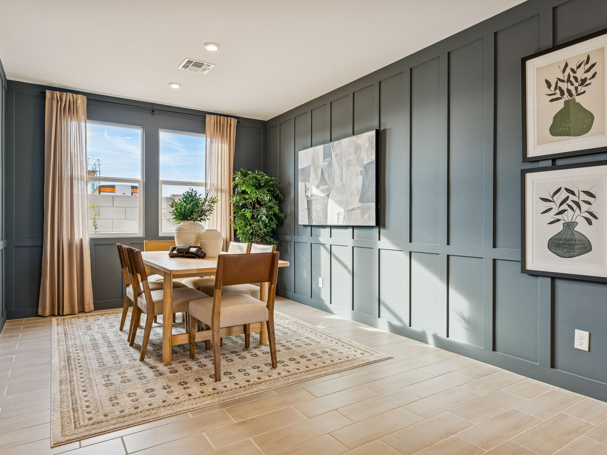 A dining room with a table and chairs.