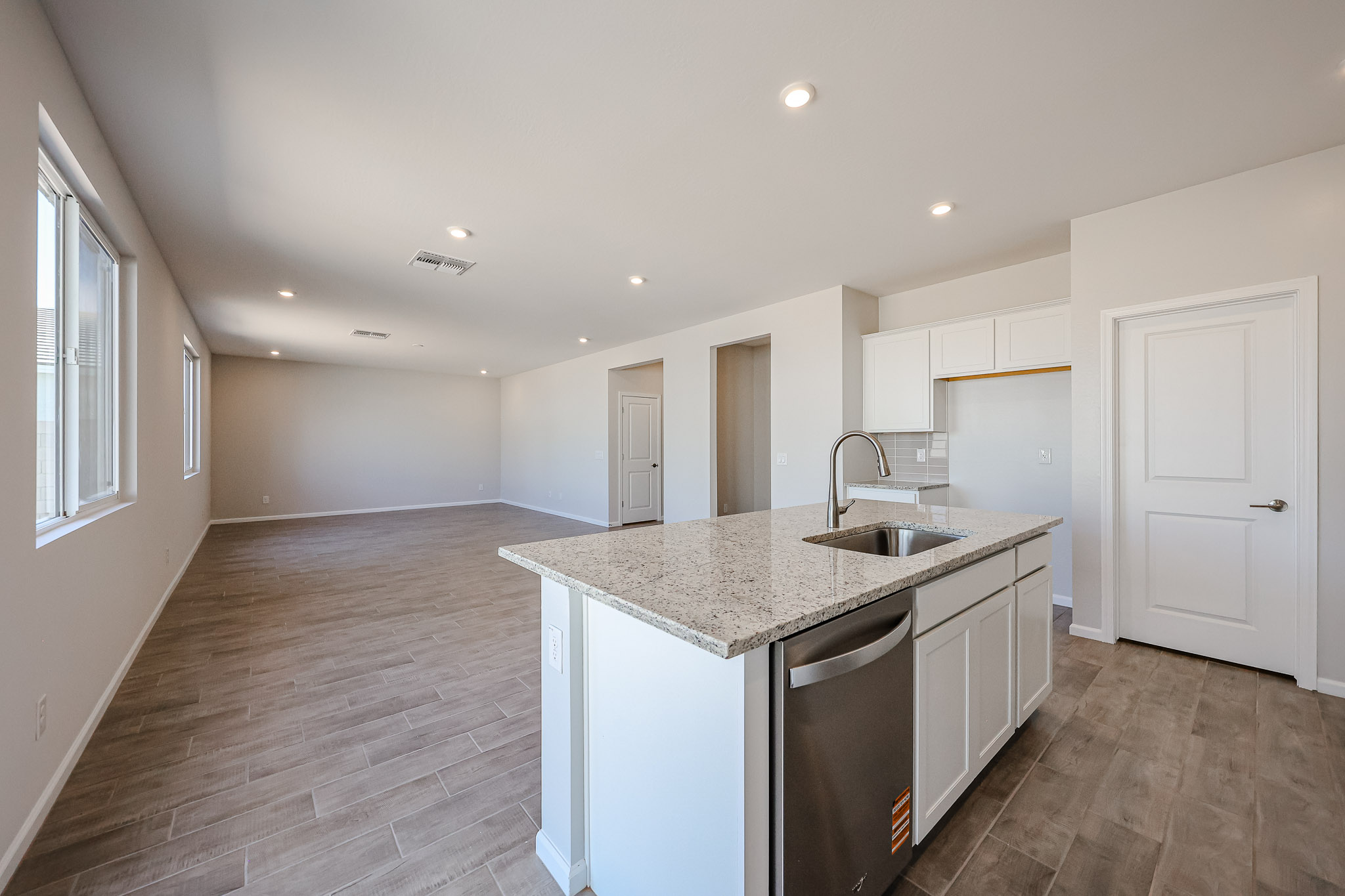 A kitchen with white cabinets.