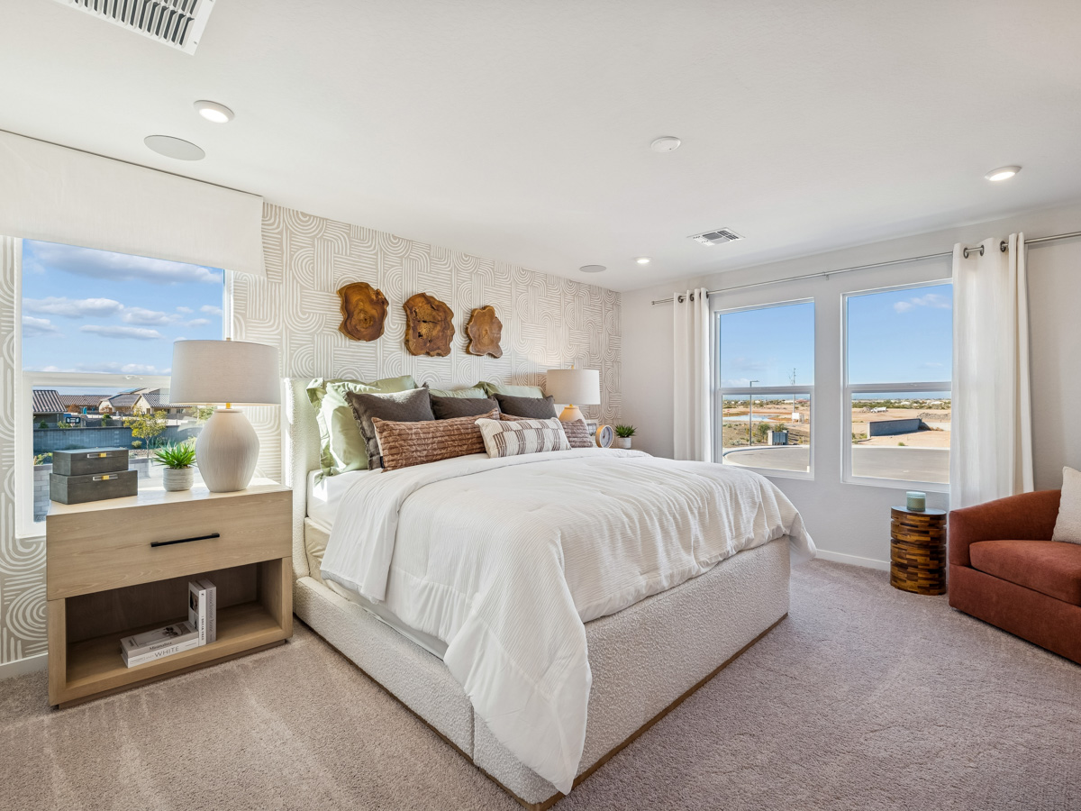 A bedroom with a large window.