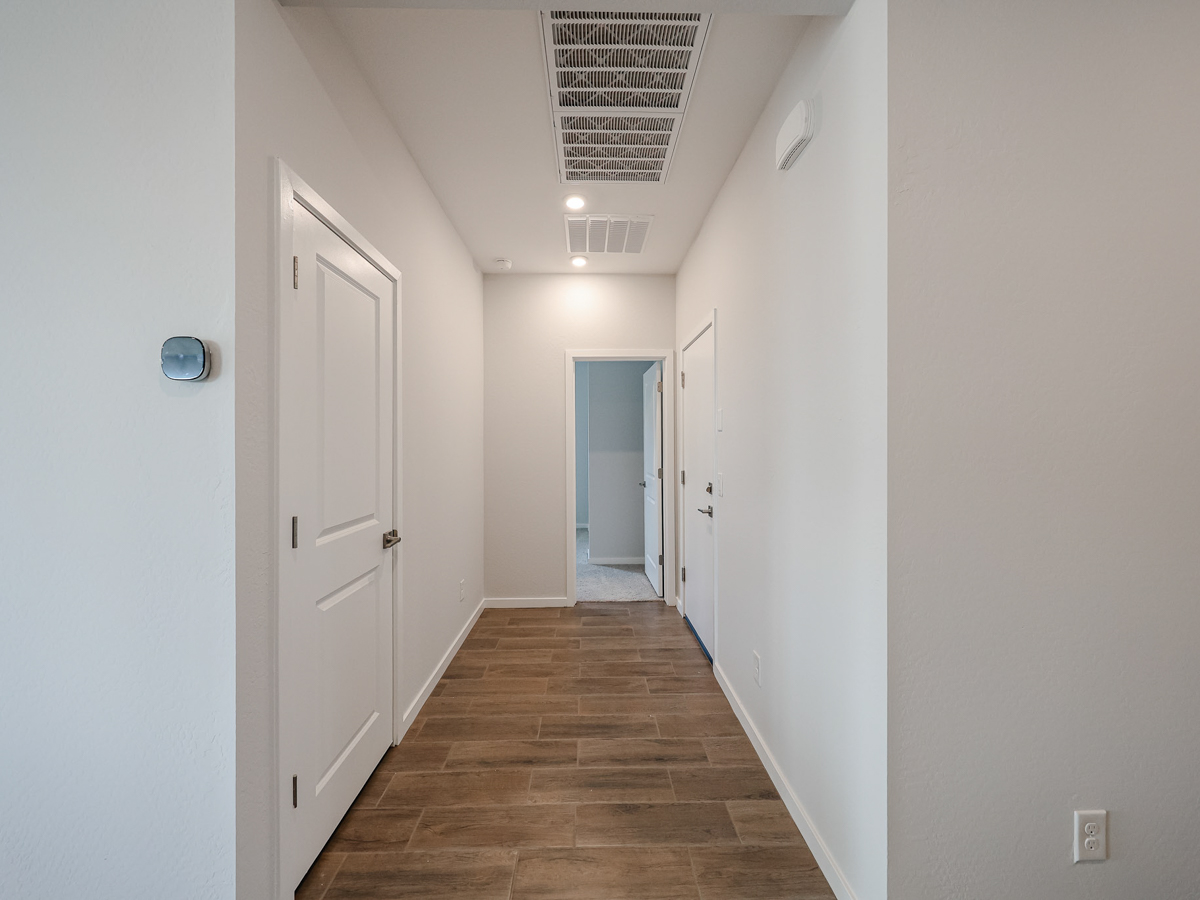A hallway with white doors.