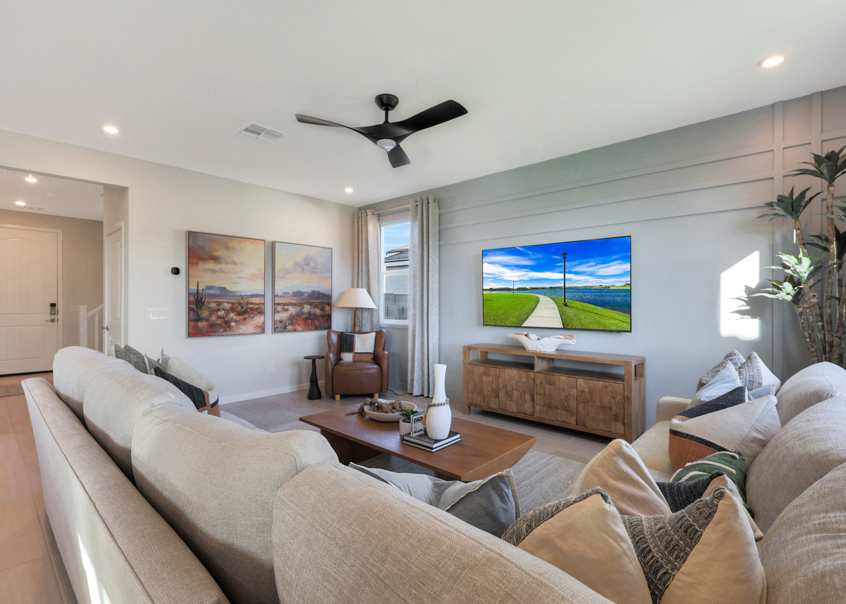 A living room with a large television.