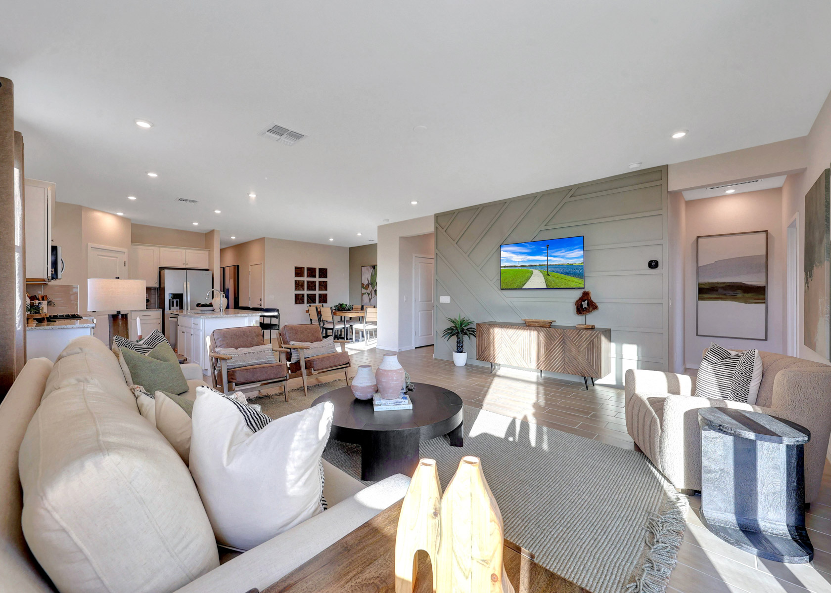 A large living room with a large tv and couches.