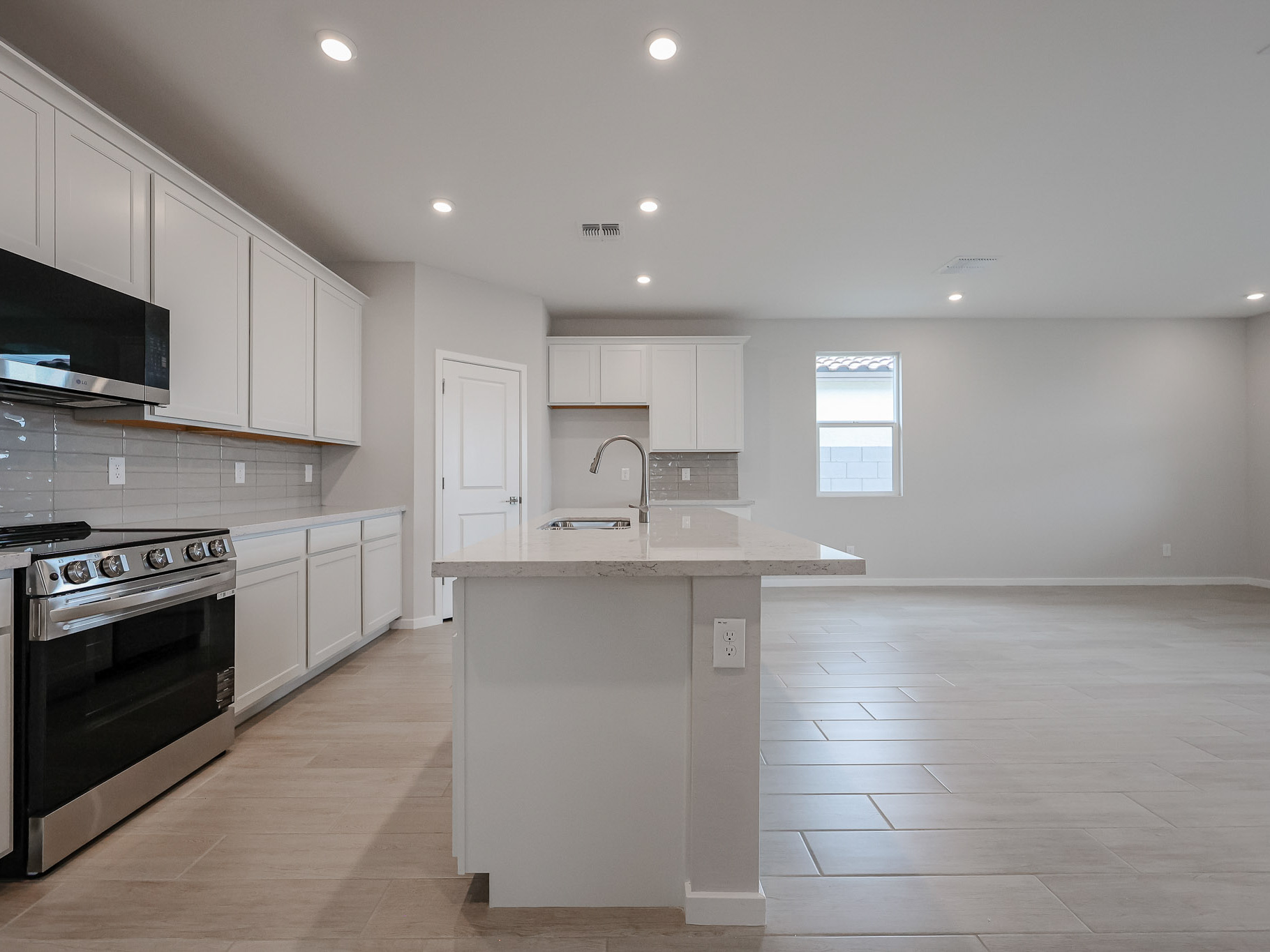 A kitchen with white cabinets.