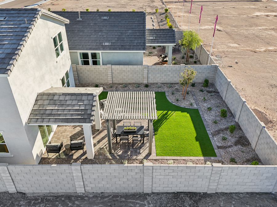 A backyard with a table and chairs.