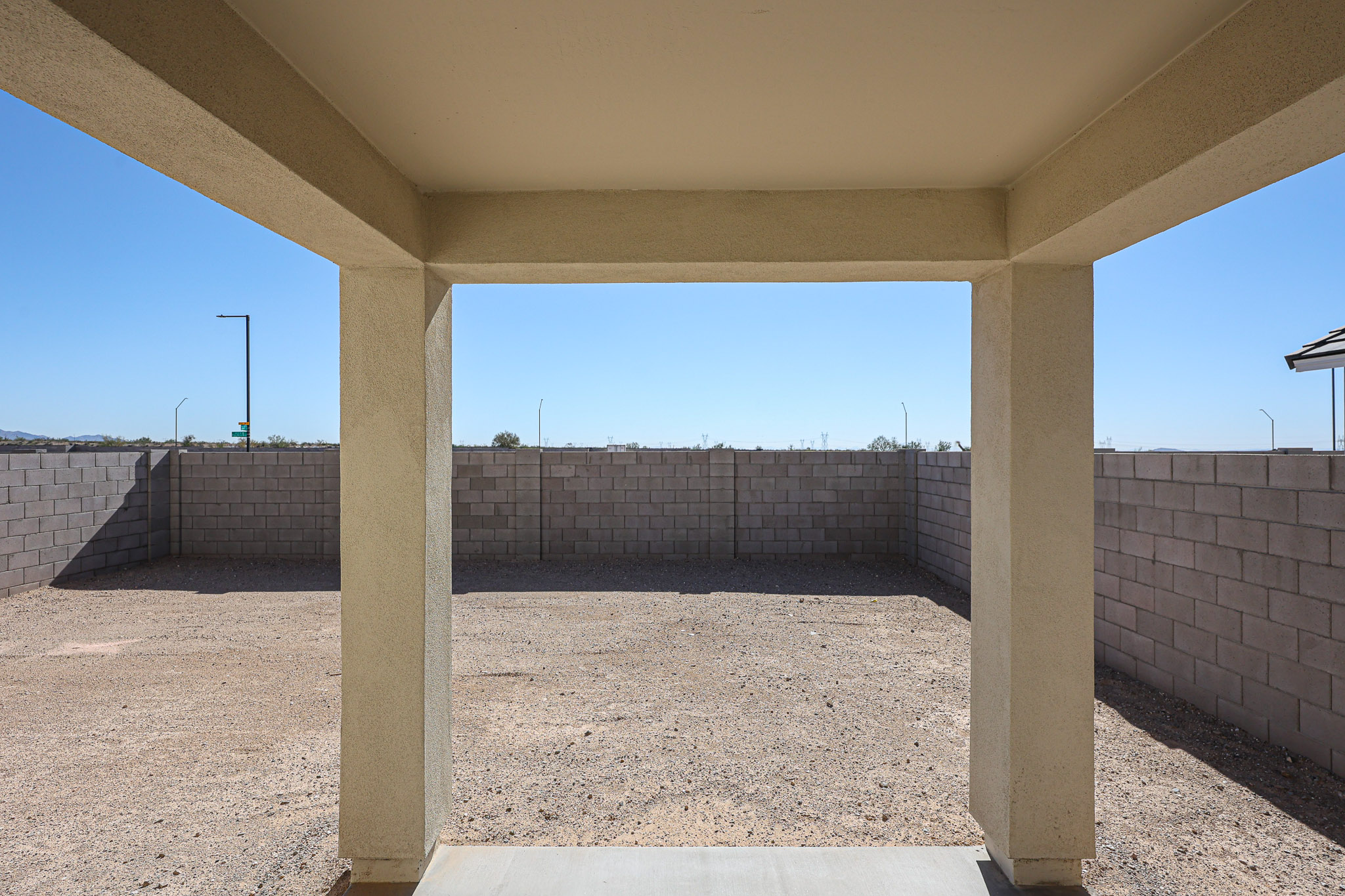 A concrete walkway with pillars.