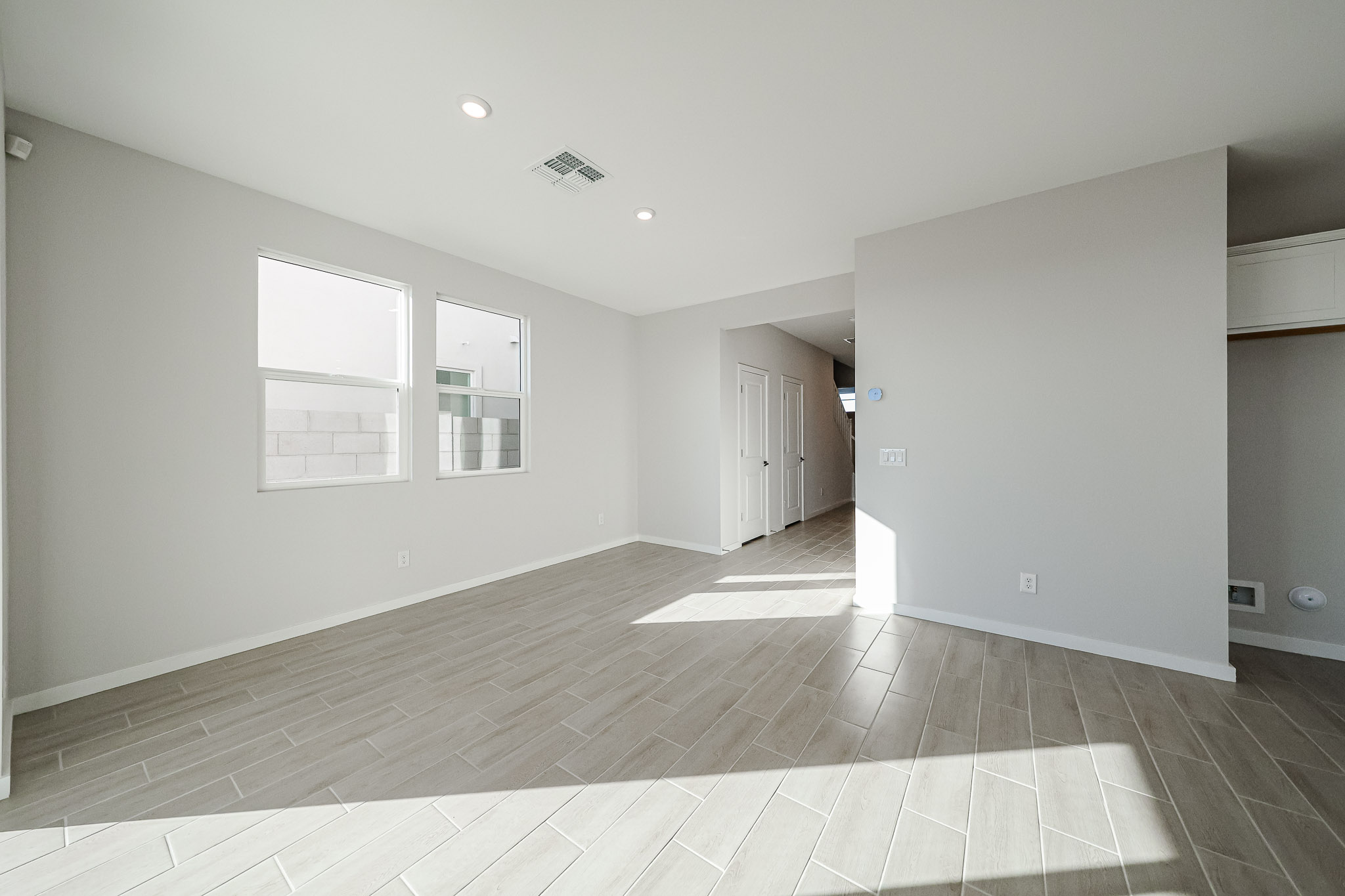A room with white walls and a wood floor.