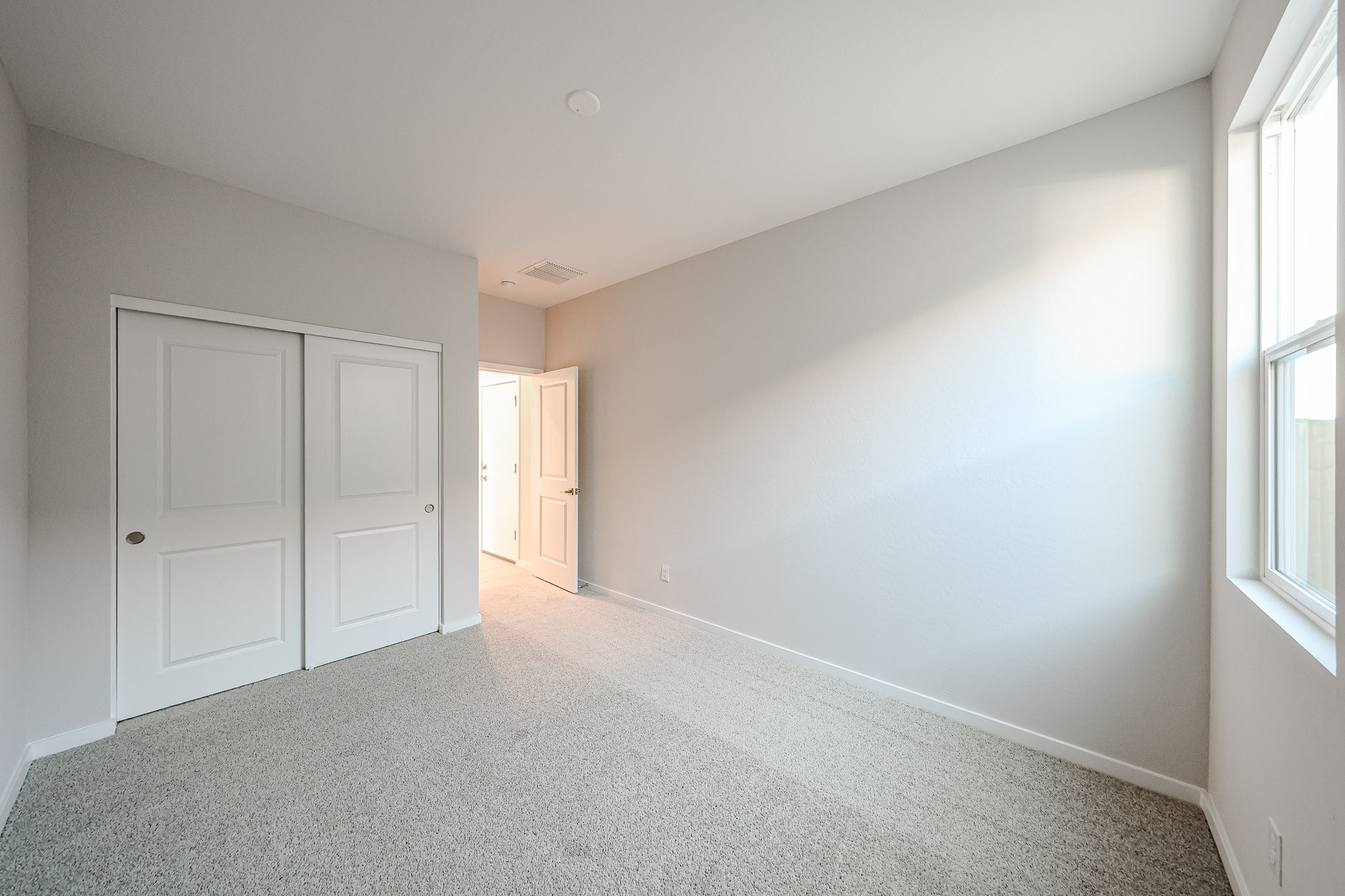 A hallway with white doors.