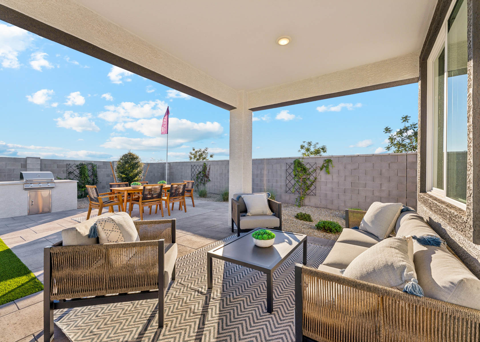 A patio with a table and chairs.