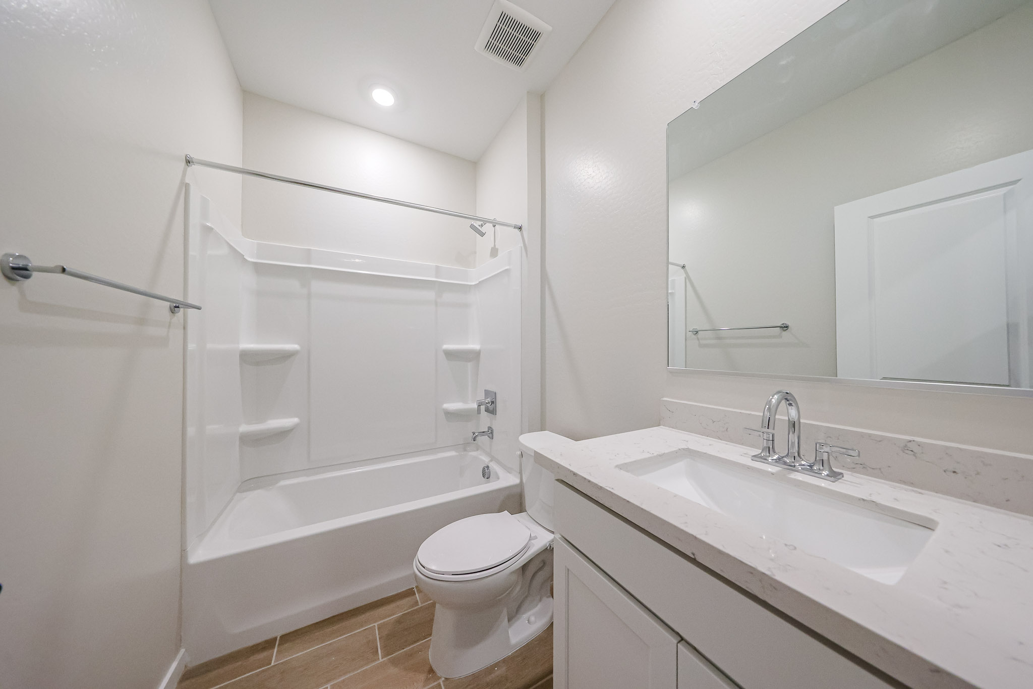 A bathroom with a tub sink and toilet.