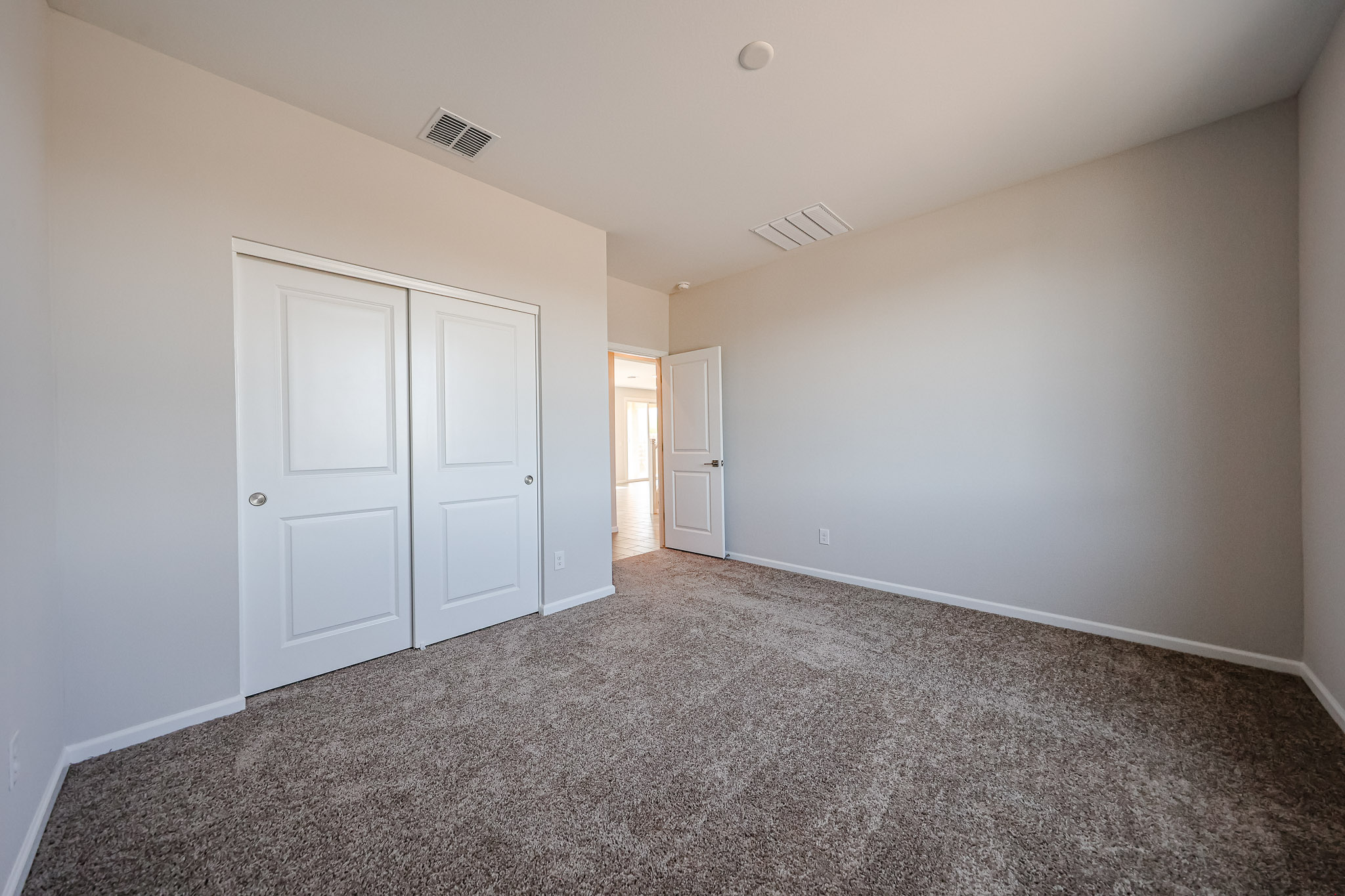 A hallway with white doors.
