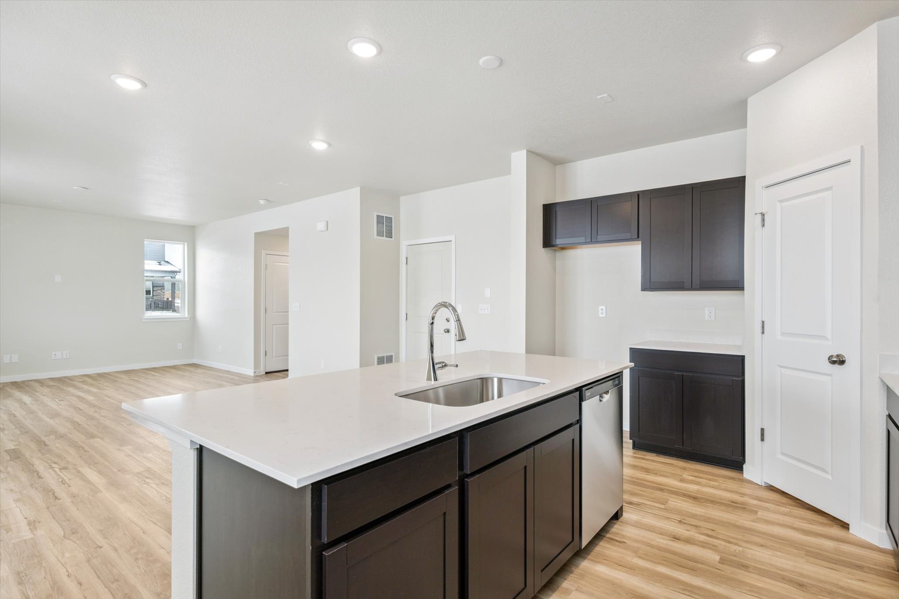 A kitchen with black cabinets.