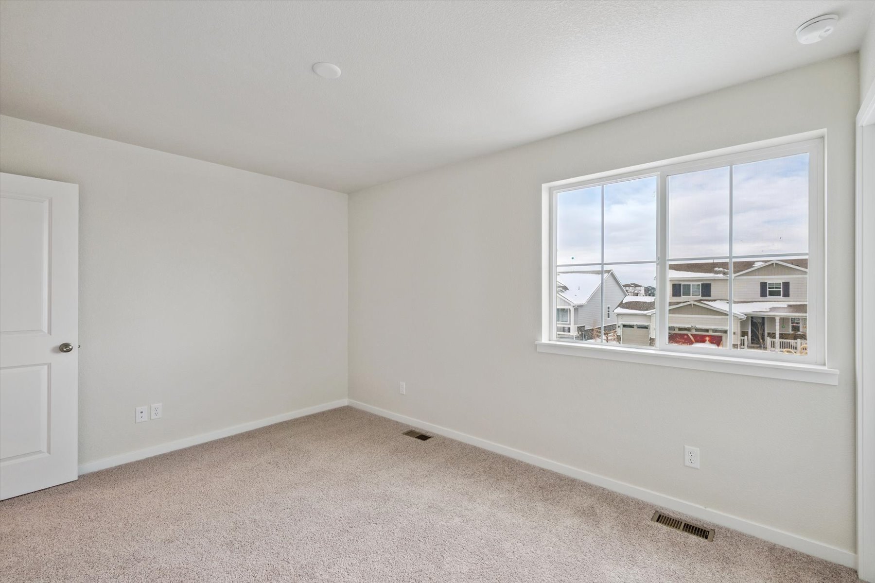 A room with a window and a door.