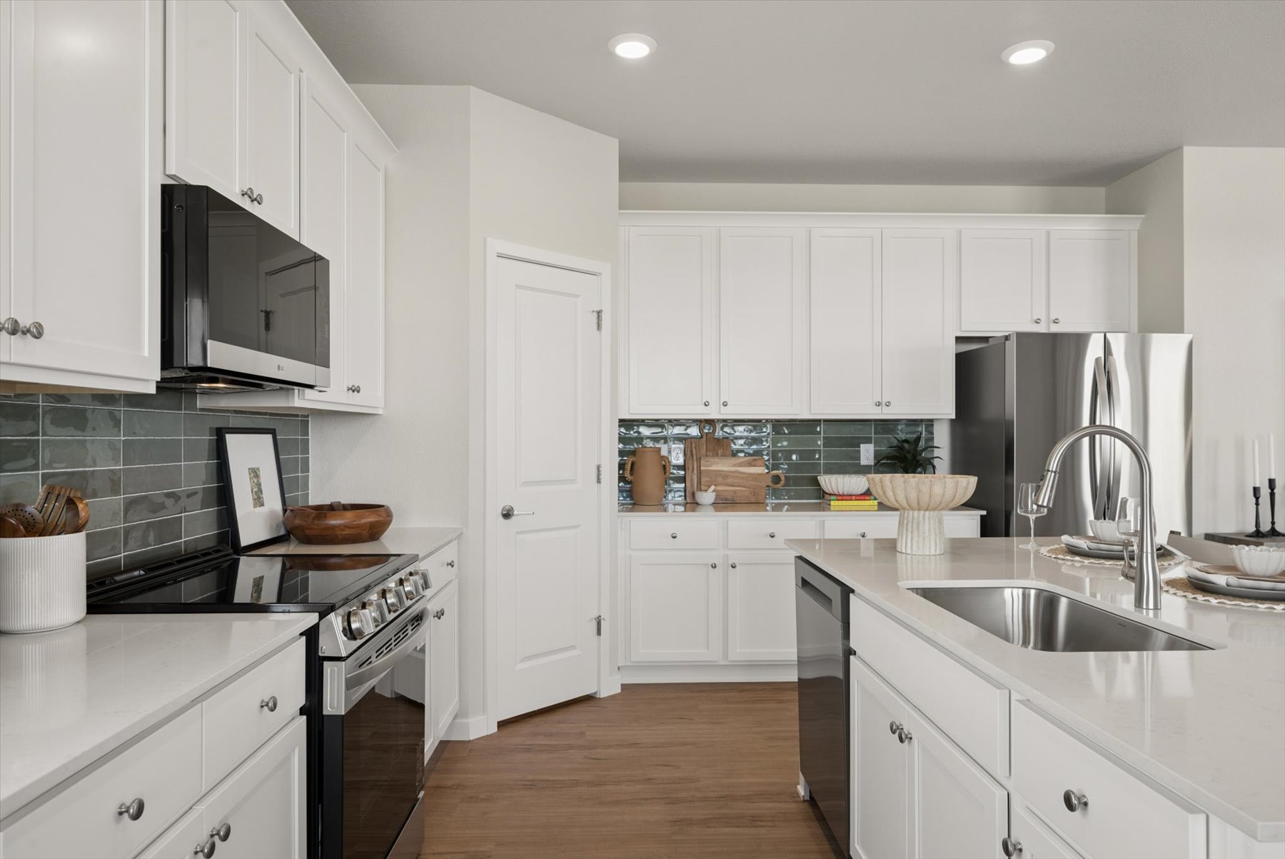 A kitchen with white cabinets.