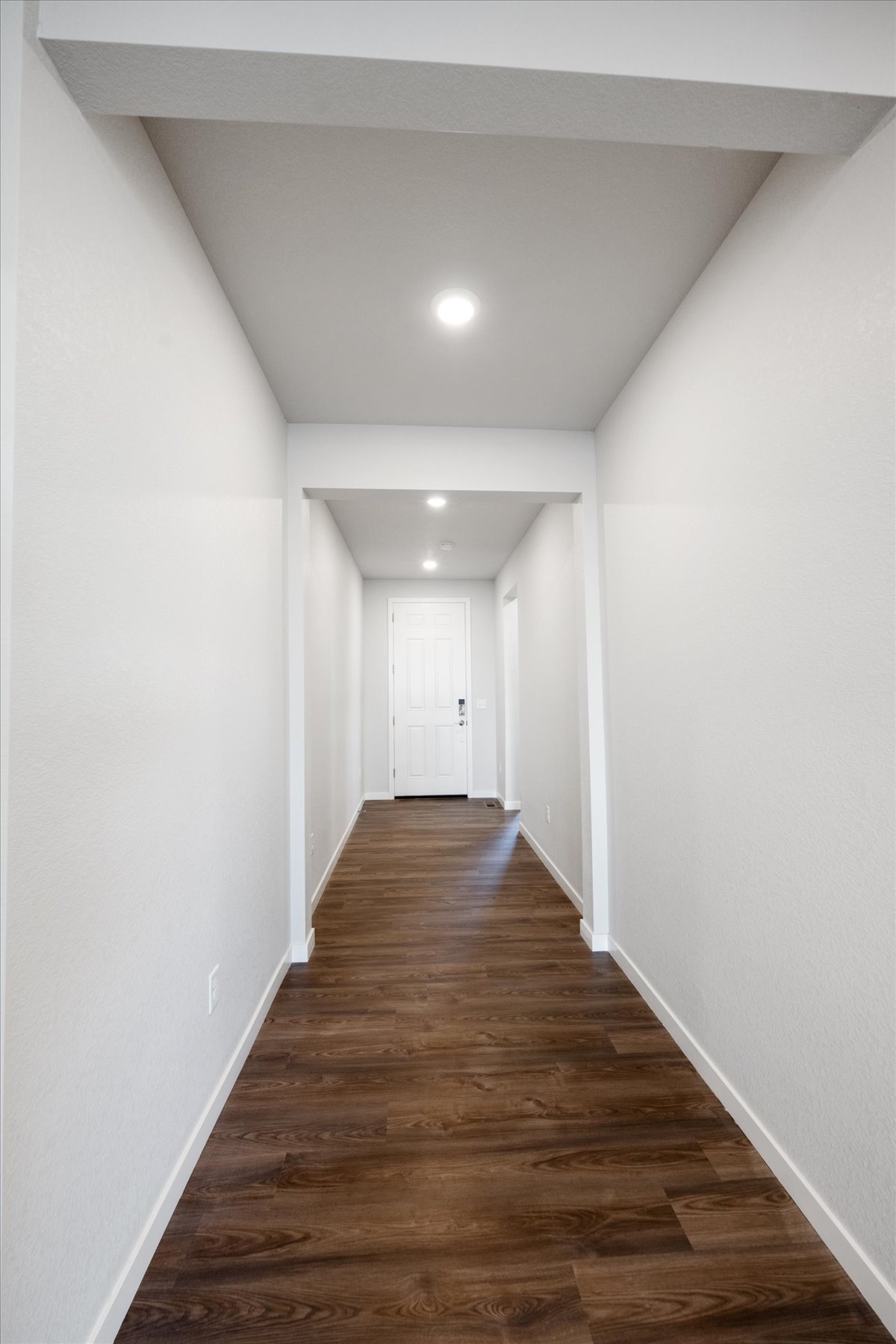 A hallway with white walls.