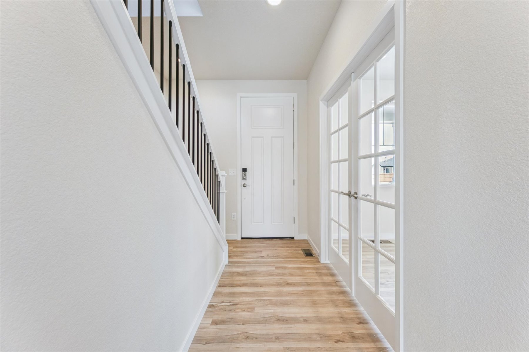 A hallway with white doors.