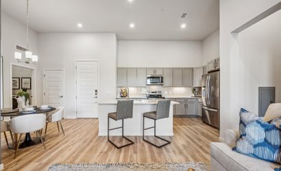 A kitchen with a dining table and chairs.