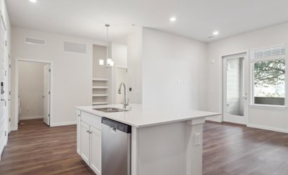 A kitchen with white cabinets.