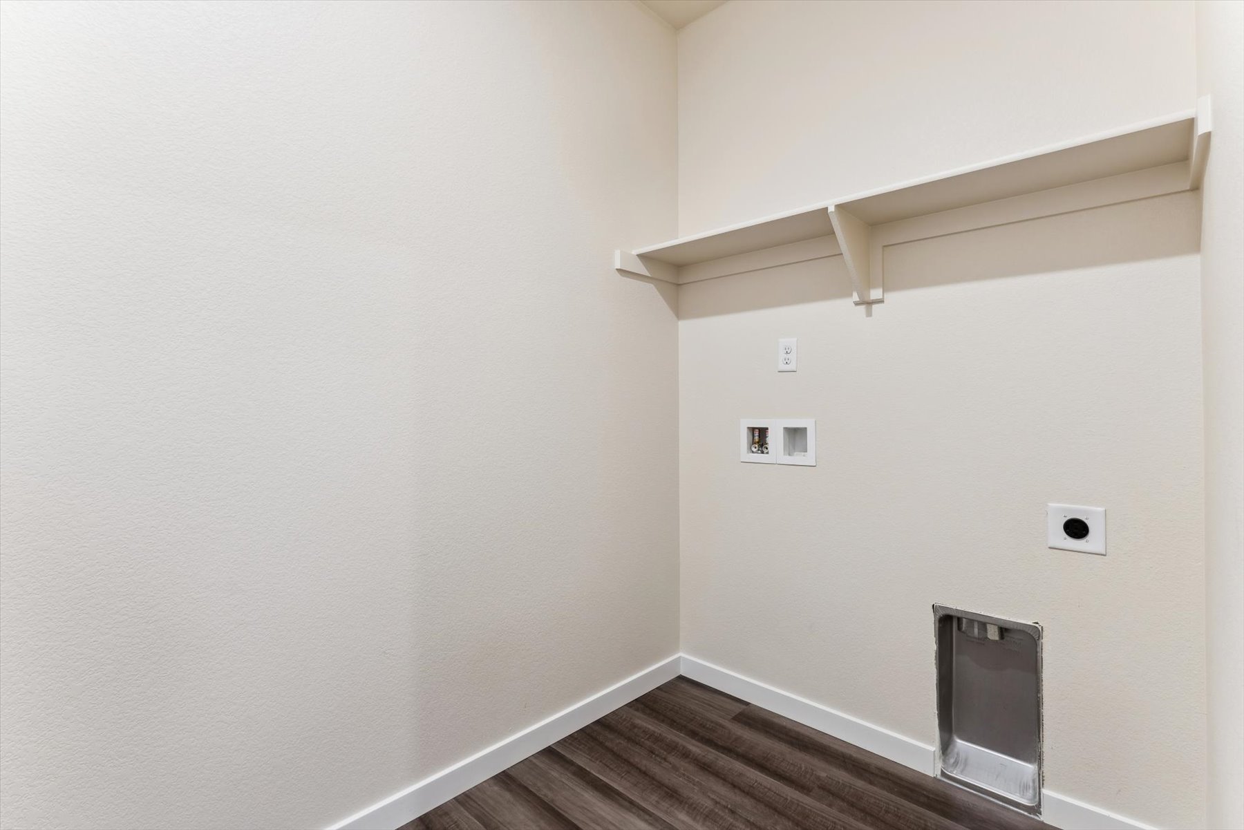 A room with a wood floor and white walls.