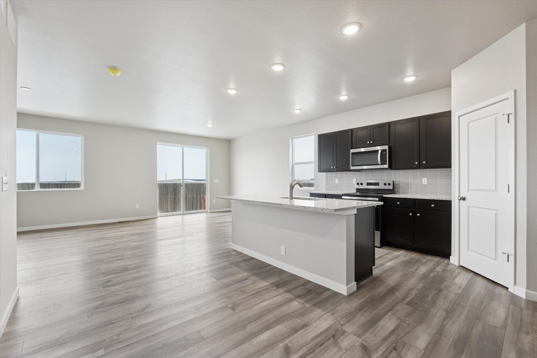 A kitchen with black cabinets.