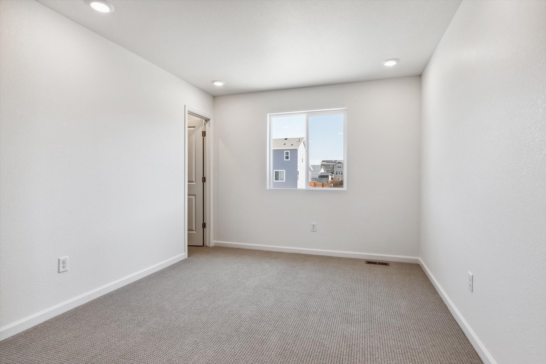 A hallway with white walls.