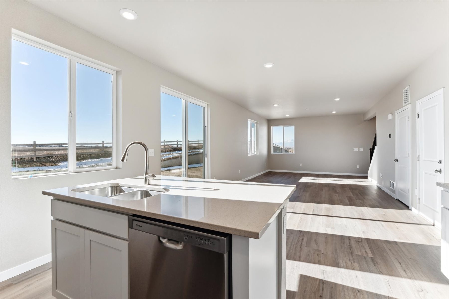 A kitchen with a large window.