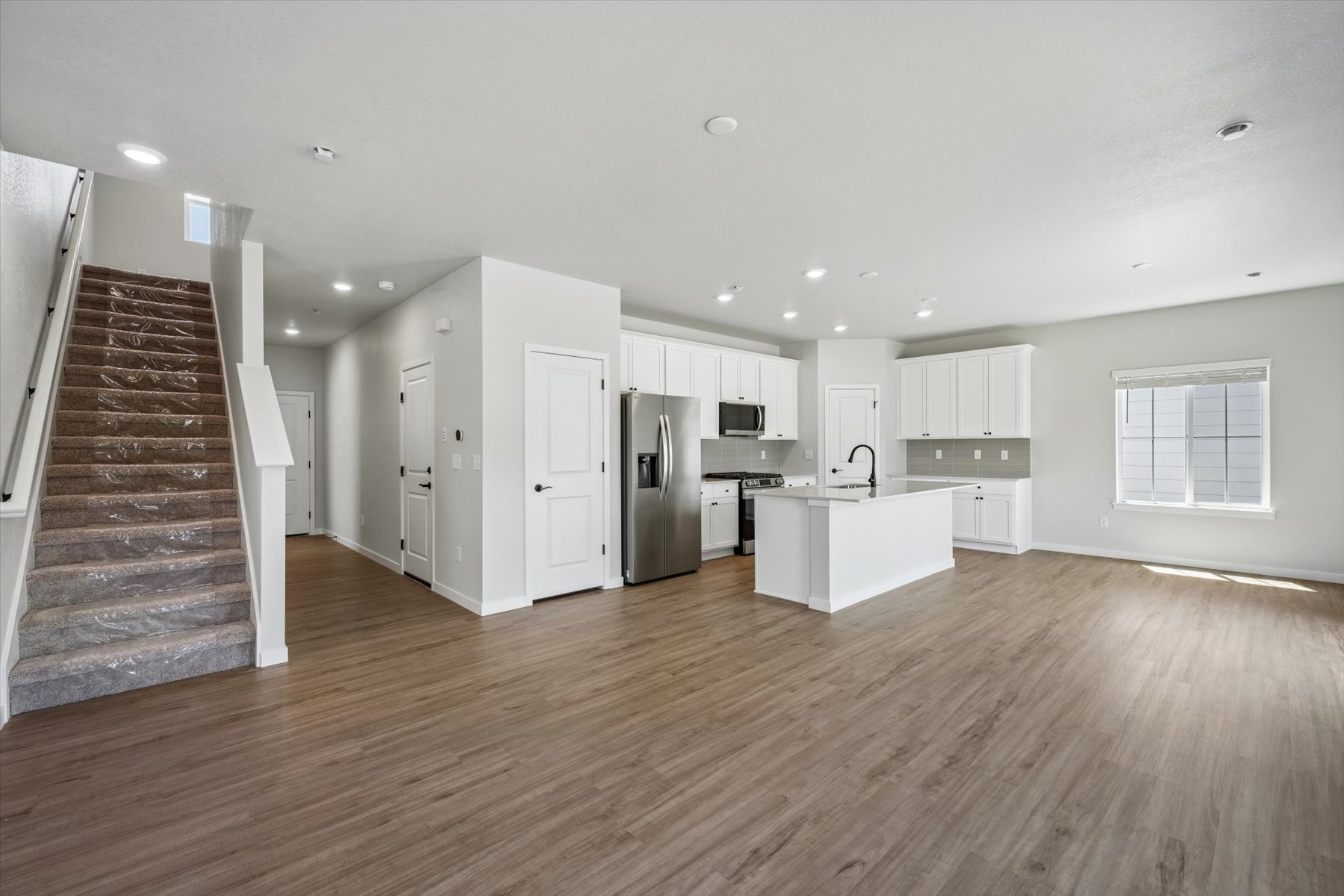 A large kitchen with white cabinets.