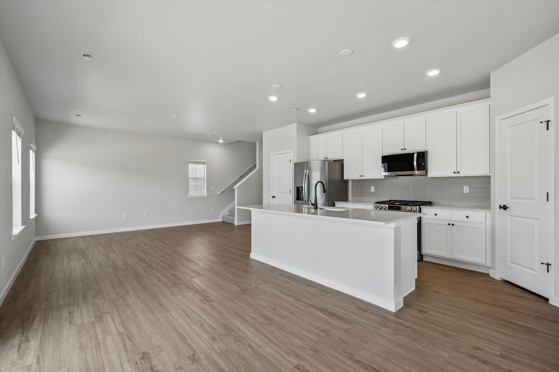 A kitchen with white cabinets.