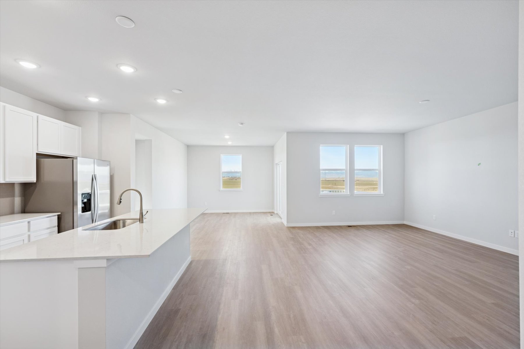 A kitchen with white cabinets.