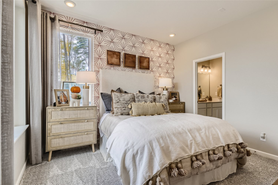 A bedroom with a bed and lamps.