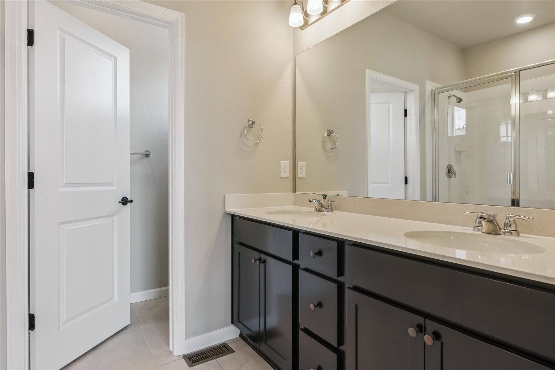 A bathroom with a large mirror.
