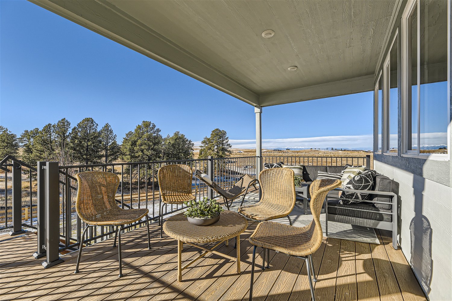 A deck with chairs and a table.