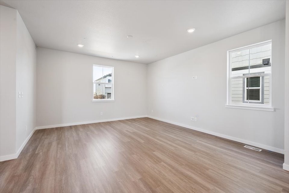A room with a wood floor and white walls.