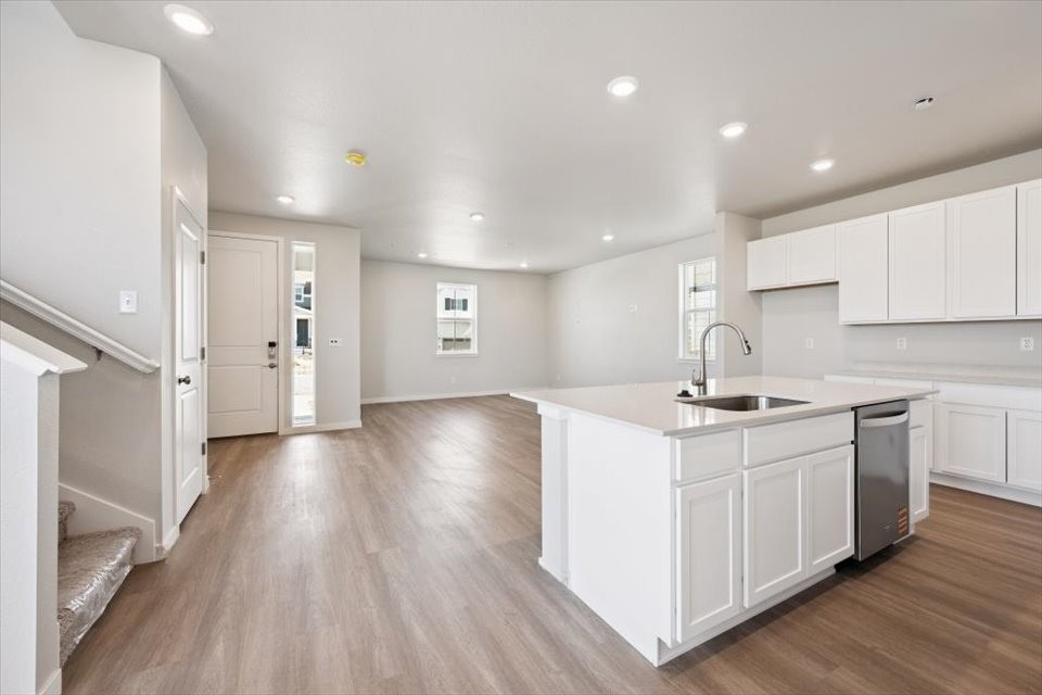 A kitchen with white cabinets.