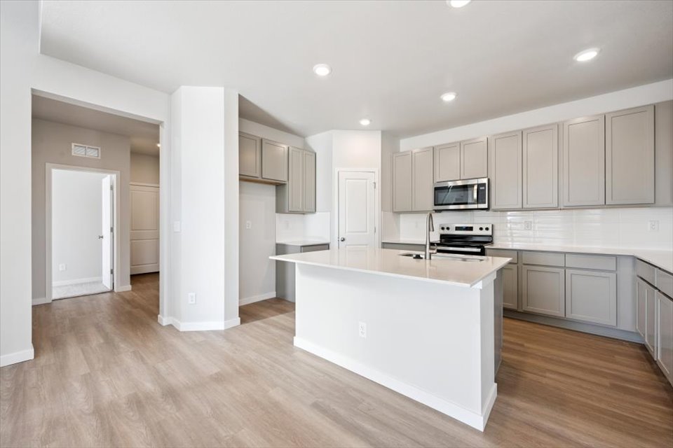 A kitchen with white cabinets.