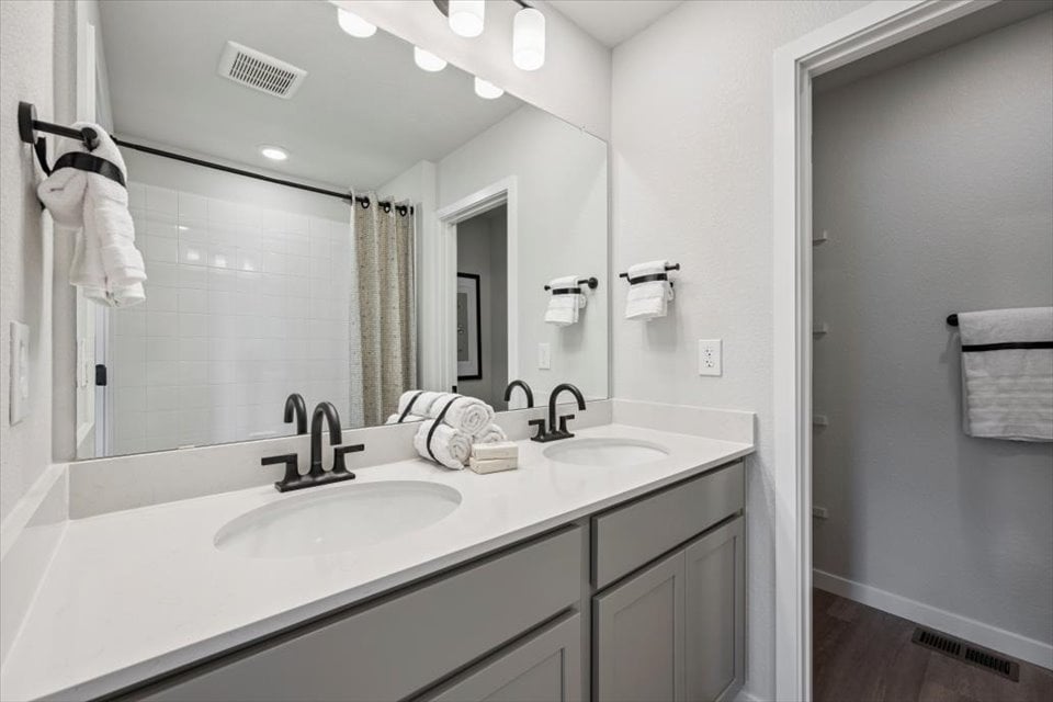 A bathroom with a large mirror.