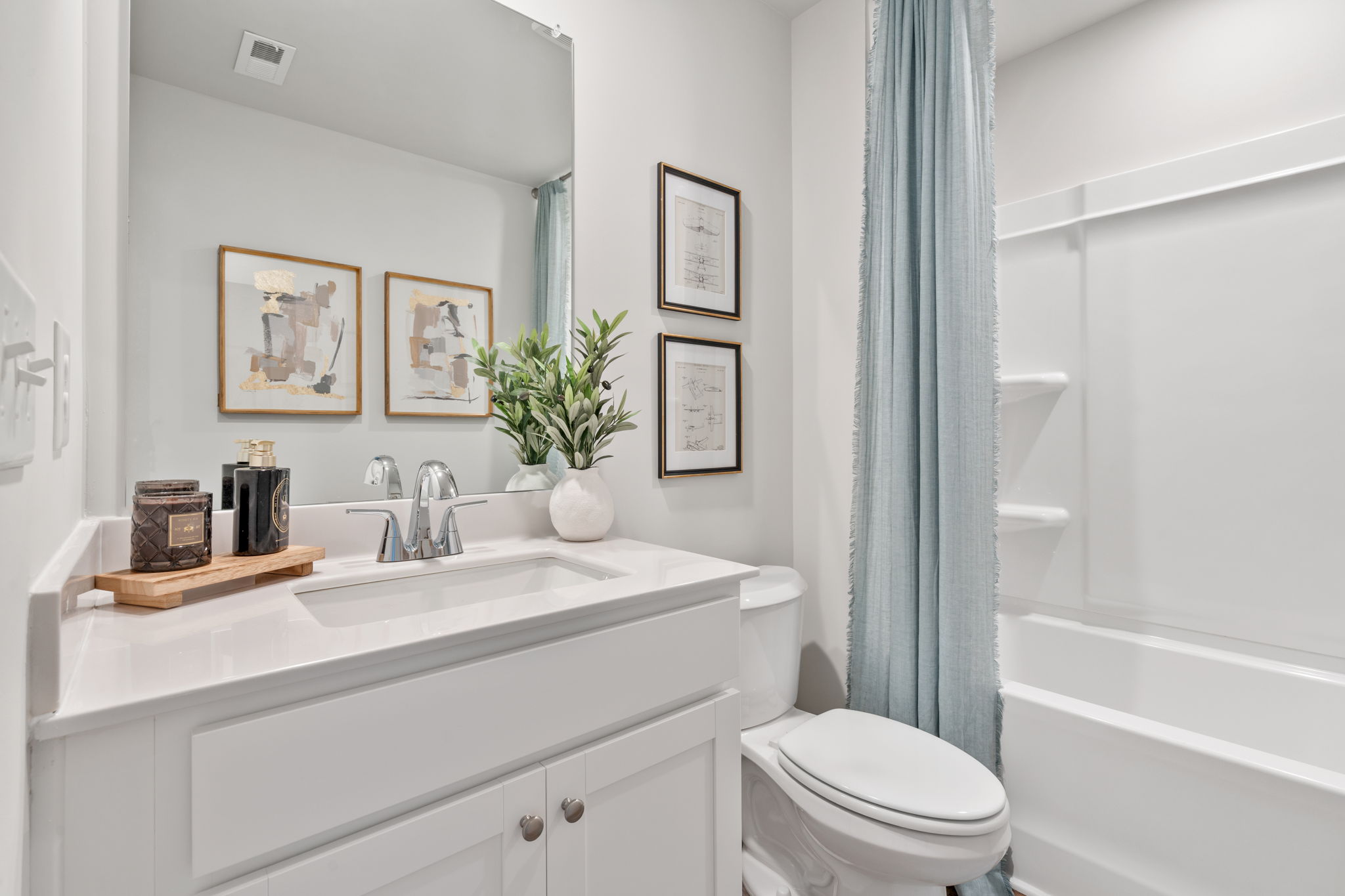 A bathroom with a sink toilet and a bathtub.