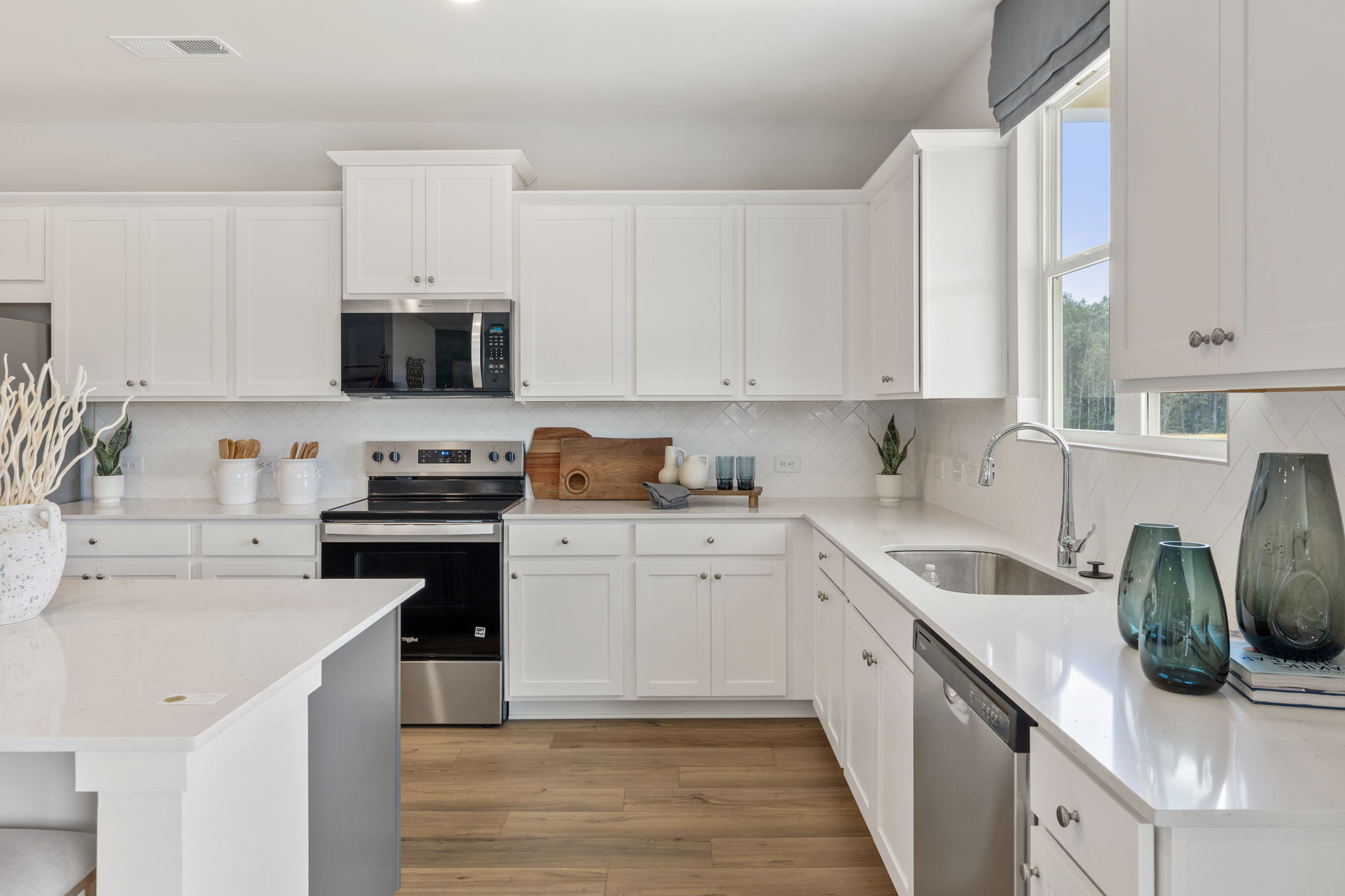 A kitchen with white cabinets.